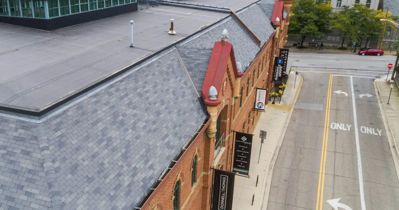 Side view of the updated Worly Building with new shingle & rubber commercial roofing.
