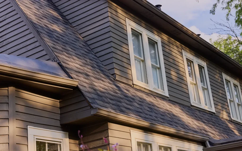 Side view of new roof installation completed by Able Roofing featuring a hybrid asphalt and low slope roof.