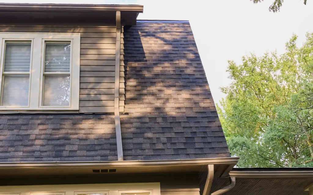Front view of a new roof installation completed by Able Roofing featuring a hybrid asphalt and low slope roof.